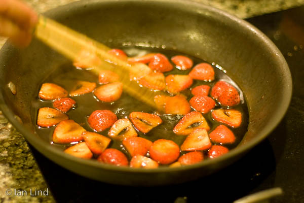 More wine and talk, then work started on the third course, pork chops with strawberries, and I'm not sure what else. After the chops were browned, they went into the oven briefly while the strawberries were sauteed in the pan drippings and other goodies.